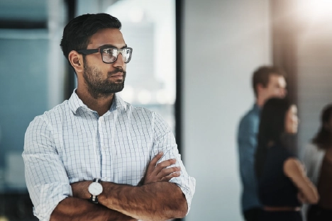 A man in a business settingwearing glasses